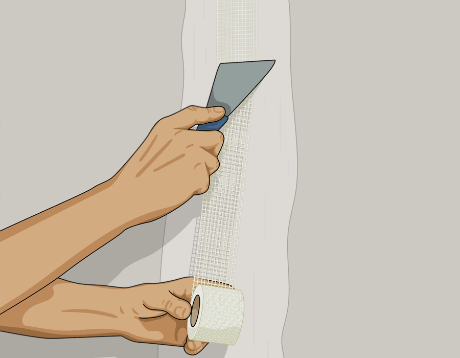 Hand som slätar ut spackelnät (skarvremsa) på gipsvägg med hjälp av en spackelspade
